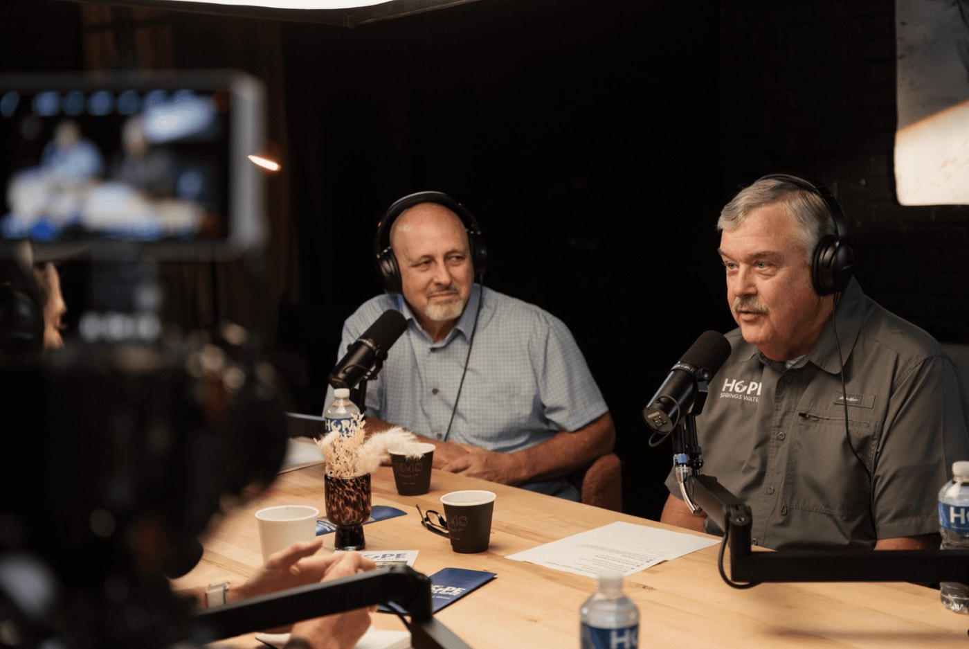 Two hosts recording in the Lightbox podcast studio